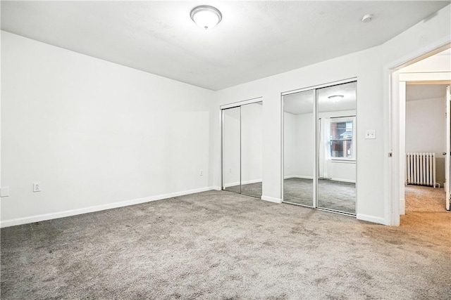 1334 Franklin Ave, Wilkinsburg, PA 15221 - unfurnished bedroom with radiator, multiple closets, and carpet flooring
