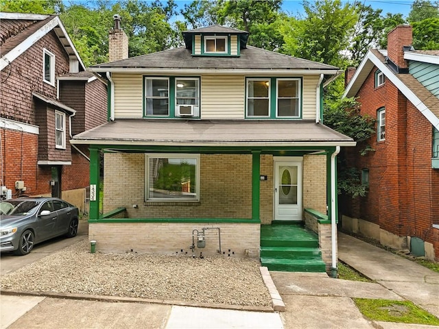 1334 Franklin Ave, Wilkinsburg, PA 15221 - traditional style home featuring a porch, brick siding, cooling unit, a chimney, and a shingled roof