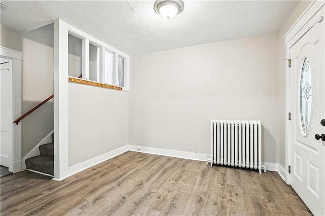 1334 Franklin Ave, Wilkinsburg, PA 15221 - foyer entrance with radiator, wood finished floors, and stairway