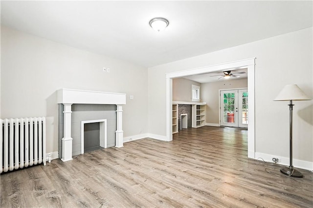 1334 Franklin Ave, Wilkinsburg, PA 15221 - unfurnished living room with radiator, wood finished floors, a ceiling fan, and french doors
