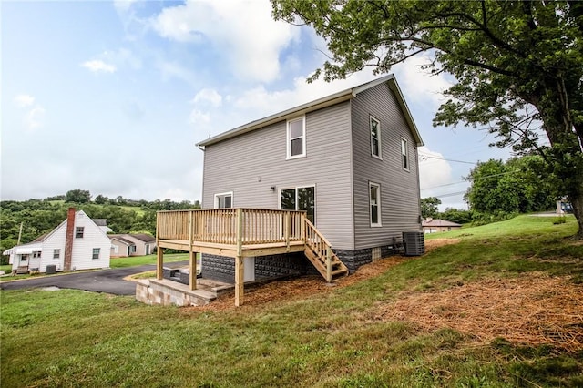 1451 W Pittsburgh St, East Huntingdon, PA 15683 - back of property with a deck and a lawn