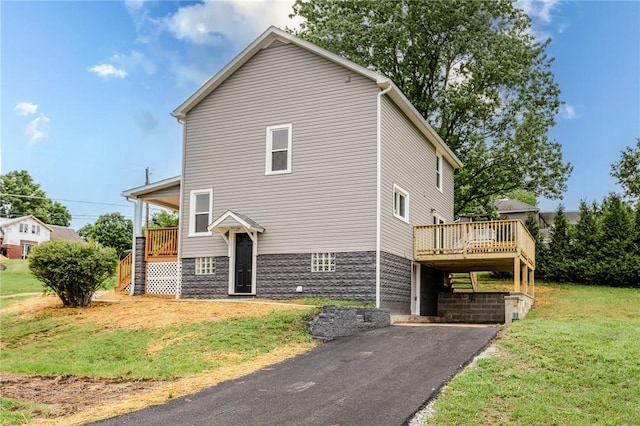 1451 W Pittsburgh St, East Huntingdon, PA 15683 - view of front of house with a front lawn, asphalt driveway, a deck, and stairway