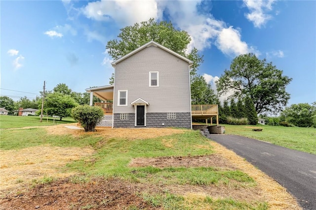 1451 W Pittsburgh St, East Huntingdon, PA 15683 - view of property exterior featuring a lawn, a deck, and driveway