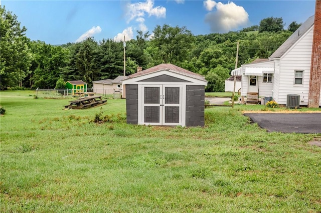 1451 W Pittsburgh St, East Huntingdon, PA 15683 - view of grassy yard featuring a storage unit and a forest view