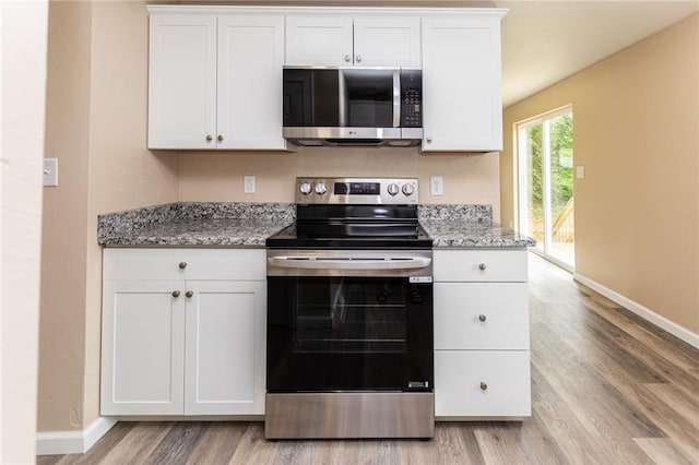 1451 W Pittsburgh St, East Huntingdon, PA 15683 - kitchen featuring stainless steel appliances, light wood finished floors, white cabinets, and light stone counters