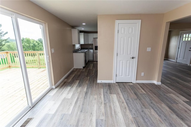 1451 W Pittsburgh St, East Huntingdon, PA 15683 - kitchen featuring wood finished floors, dark countertops, white cabinets, recessed lighting, and stainless steel fridge with ice dispenser