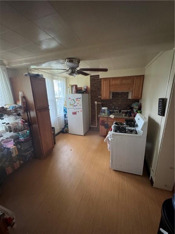 125 Frazier Ave, Stowe Twp, PA 15136 - kitchen with white appliances, ceiling fan, brown cabinetry, and light wood-style floors