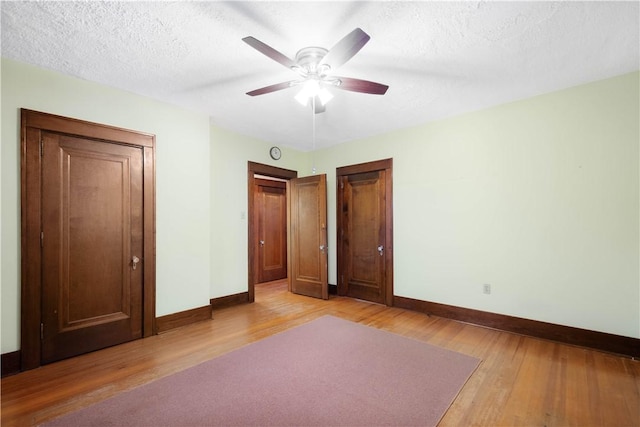 512 Gorgas St, Arlington, PA 15210 - unfurnished bedroom with light wood-type flooring, a textured ceiling, and ceiling fan