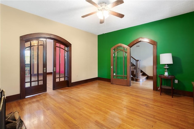 512 Gorgas St, Arlington, PA 15210 - spare room featuring arched walkways, wood finished floors, and a ceiling fan
