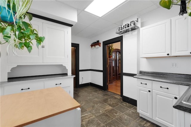 512 Gorgas St, Arlington, PA 15210 - kitchen featuring white cabinets, a paneled ceiling, and dark countertops