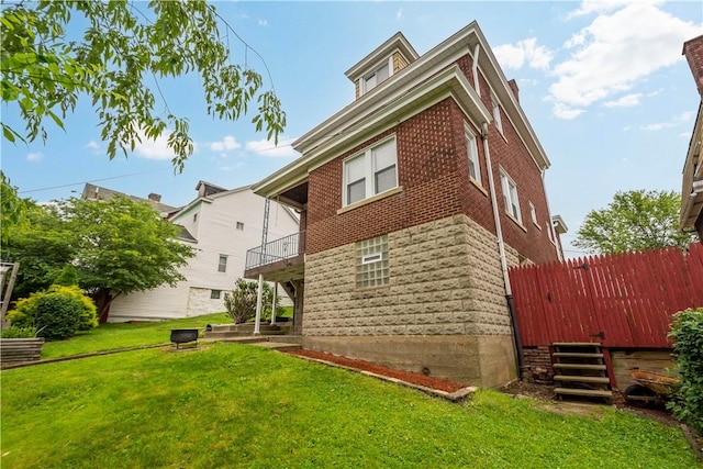 512 Gorgas St, Arlington, PA 15210 - back of house featuring a lawn, brick siding, and a balcony