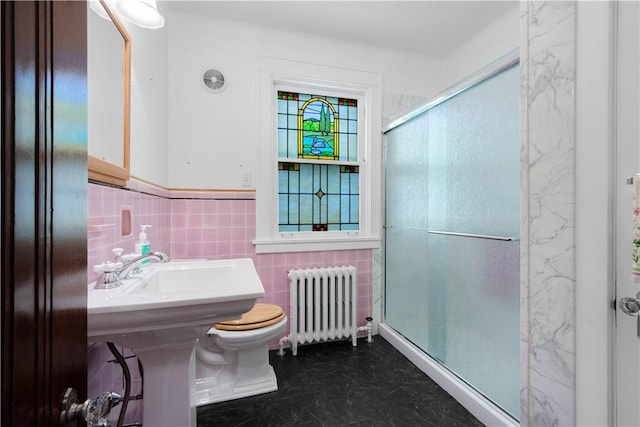 512 Gorgas St, Arlington, PA 15210 - bathroom with radiator, tile walls, a stall shower, and wainscoting