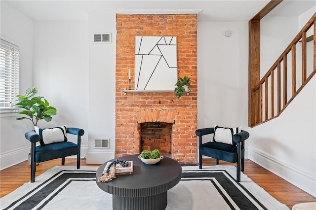 3817 Howley St, Lawrenceville, PA 15201 - sitting room featuring wood finished floors, a fireplace, and stairway