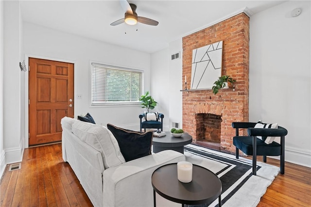 3817 Howley St, Lawrenceville, PA 15201 - living room with hardwood / wood-style floors, a brick fireplace, and ceiling fan