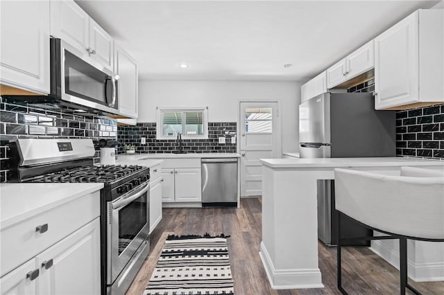3817 Howley St, Lawrenceville, PA 15201 - kitchen with stainless steel appliances, tasteful backsplash, white cabinets, light countertops, and dark wood-style flooring