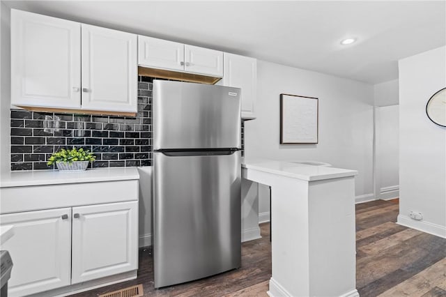 3817 Howley St, Lawrenceville, PA 15201 - kitchen featuring freestanding refrigerator, white cabinetry, dark wood-style flooring, backsplash, and recessed lighting