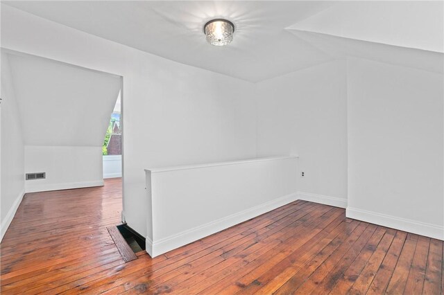 3817 Howley St, Lawrenceville, PA 15201 - empty room with hardwood / wood-style flooring and vaulted ceiling