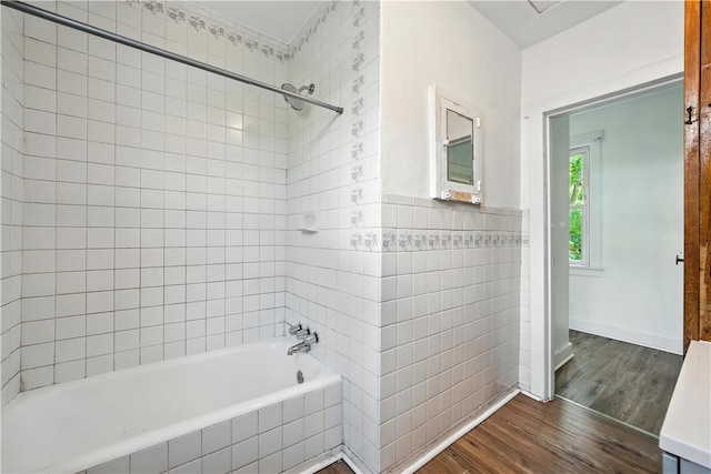 2505 Gable St, South Side, PA 15210 - full bathroom featuring tile walls, wood finished floors, tiled shower / bath combo, and wainscoting
