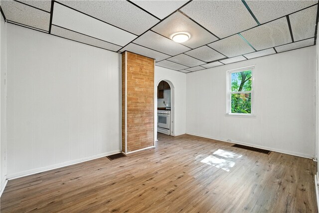 2505 Gable St, South Side, PA 15210 - spare room with arched walkways, hardwood / wood-style floors, and a drop ceiling