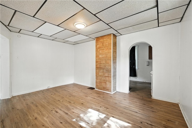 2505 Gable St, South Side, PA 15210 - empty room featuring arched walkways, wood finished floors, and a drop ceiling