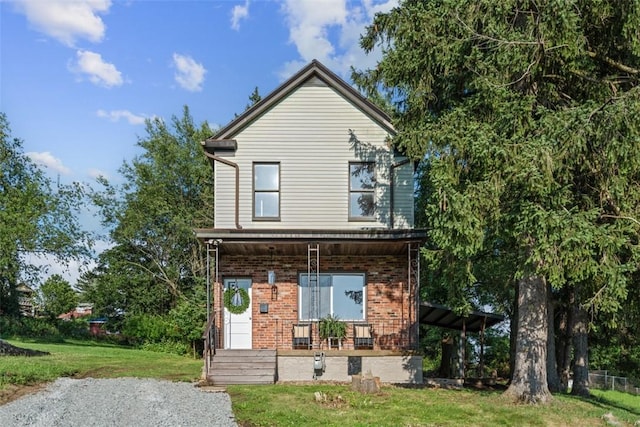 450 Penn St, Baldwin Boro, PA 15227 - view of front facade with covered porch, brick siding, and a front yard