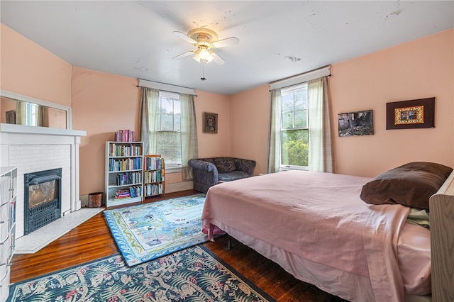 6517 Aylesboro Ave, Squirrel Hill, PA 15217 - bedroom featuring wood finished floors, multiple windows, a brick fireplace, and a ceiling fan