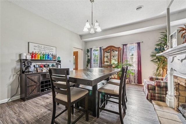 27 Richeyville Rd, Centerville, PA 15358 - dining area with a chandelier, a dry bar, wood finished floors, and a fireplace