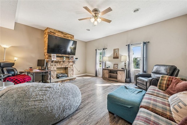 27 Richeyville Rd, Centerville, PA 15358 - living area with a ceiling fan, wood finished floors, a fireplace, and a textured ceiling