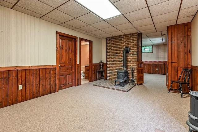117 Oak Dr, Forward Twp But, PA 16033 - finished below grade area with a wood stove, a wainscoted wall, wooden walls, carpet floors, and a drop ceiling