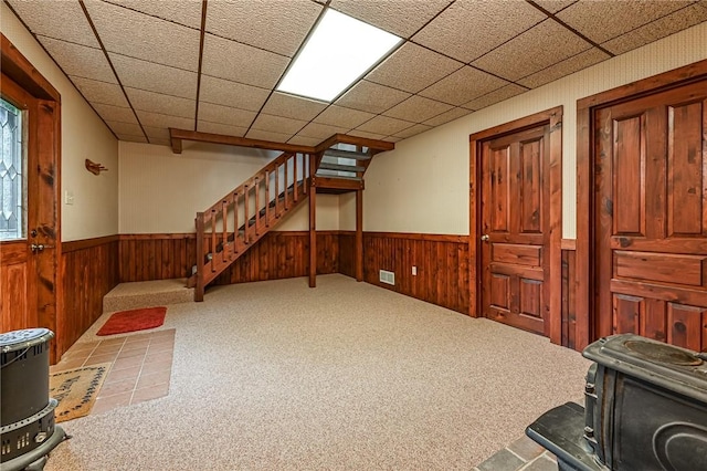 117 Oak Dr, Forward Twp But, PA 16033 - below grade area featuring a wood stove, wainscoting, stairway, wooden walls, and carpet floors