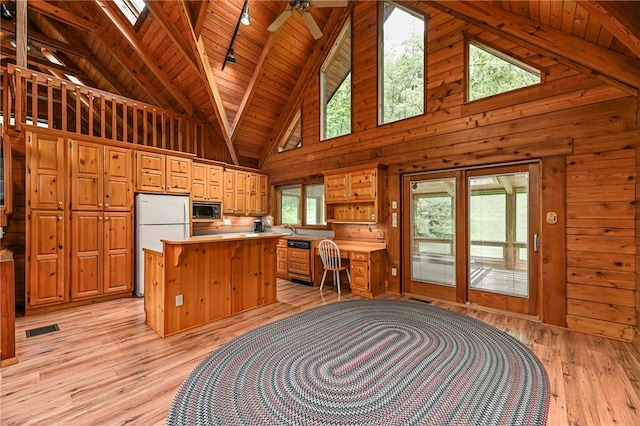 117 Oak Dr, Forward Twp But, PA 16033 - kitchen featuring black microwave, freestanding refrigerator, wood walls, a wooden ceiling with exposed beams, and light countertops