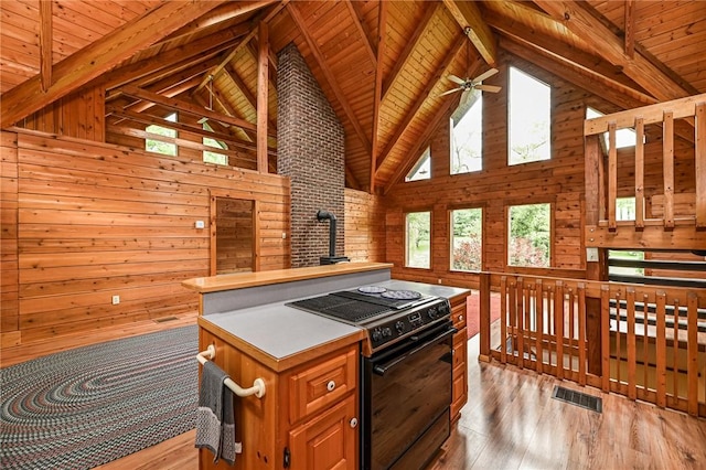 117 Oak Dr, Forward Twp But, PA 16033 - kitchen with black range with electric cooktop, high vaulted ceiling, light wood finished floors, wooden walls, and a wood ceiling with exposed beams