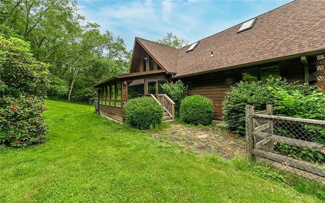 117 Oak Dr, Forward Twp But, PA 16033 - view of side of property featuring a shingled roof, a sunroom, and a yard