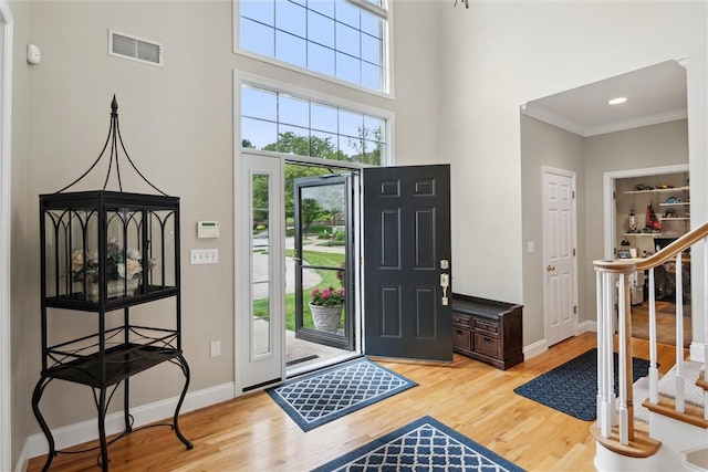 1500 Zenith Ct, Upper St Clair, PA 15241 - entryway featuring light wood finished floors, stairs, a towering ceiling, and crown molding