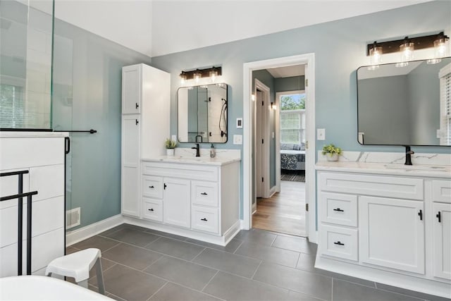 1500 Zenith Ct, Upper St Clair, PA 15241 - ensuite bathroom featuring two vanities, a shower stall, tile patterned floors, and a freestanding tub