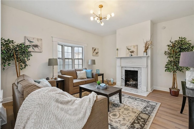516 Division Ave, Bellevue, PA 15202 - living area with a chandelier, light wood finished floors, and a premium fireplace