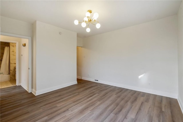 516 Division Ave, Bellevue, PA 15202 - spare room with a chandelier and wood finished floors