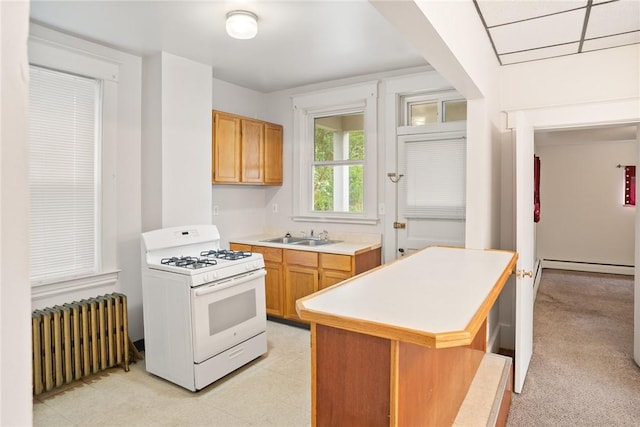 97 N Euclid Ave, Bellevue, PA 15202 - kitchen with white gas range, radiator heating unit, light countertops, a baseboard heating unit, and a center island