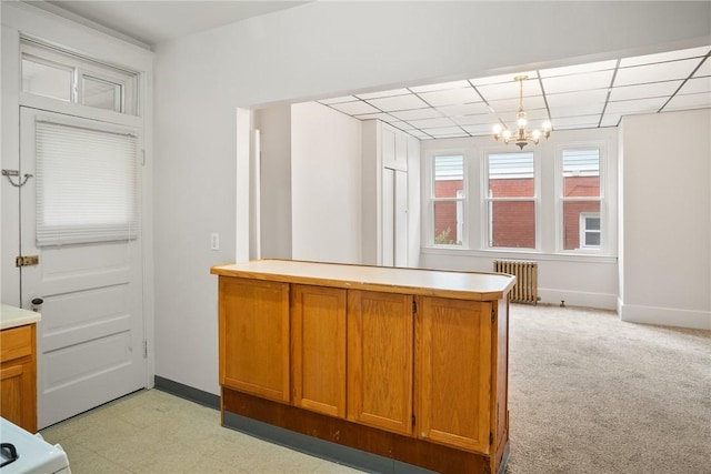 97 N Euclid Ave, Bellevue, PA 15202 - kitchen with radiator, light countertops, brown cabinetry, a chandelier, and a peninsula