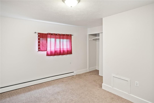 97 N Euclid Ave, Bellevue, PA 15202 - unfurnished bedroom with a baseboard radiator, carpet flooring, a closet, and a textured ceiling