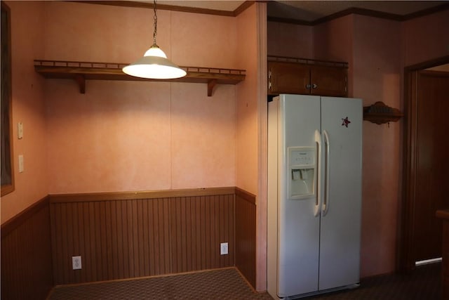 115 Pike Ave, North Beaver Twp, PA 16102 - kitchen featuring white refrigerator with ice dispenser, wainscoting, hanging light fixtures, crown molding, and a breakfast bar