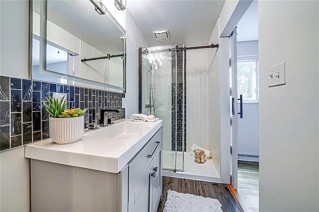 150 Dover Dr, Moon/Crescent Twp, PA 15108 - full bath featuring a stall shower, vanity, wood finished floors, backsplash, and a baseboard radiator