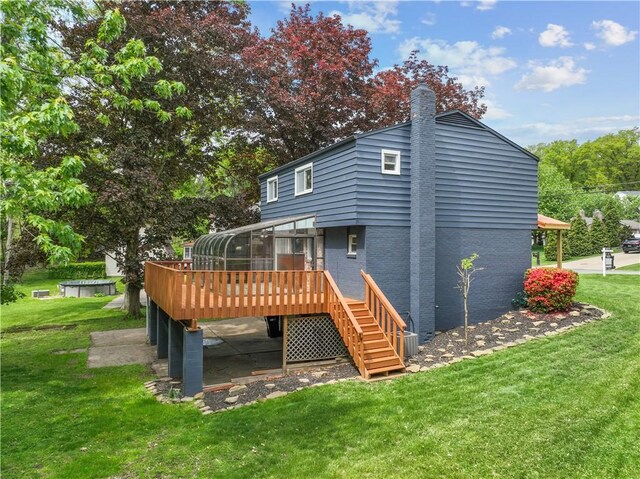 150 Dover Dr, Moon/Crescent Twp, PA 15108 - back of house featuring a deck, brick siding, a chimney, a lawn, and stairs