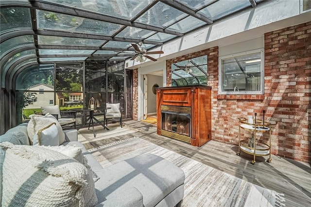 150 Dover Dr, Moon/Crescent Twp, PA 15108 - unfurnished sunroom with a glass covered fireplace, ceiling fan, and outdoor dining area