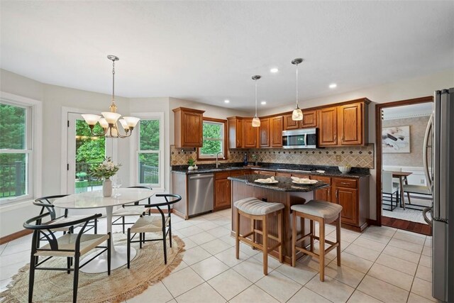 105 Averys Way, Cranberry Twp, PA 16066 - kitchen featuring appliances with stainless steel finishes, brown cabinetry, a kitchen island, decorative backsplash, and recessed lighting
