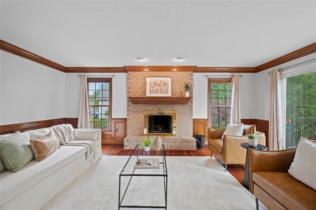 105 Averys Way, Cranberry Twp, PA 16066 - living area with a wainscoted wall, wood finished floors, plenty of natural light, ornamental molding, and a brick fireplace