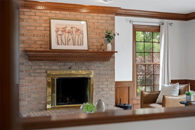 105 Averys Way, Cranberry Twp, PA 16066 - living area with wainscoting, a brick fireplace, and crown molding