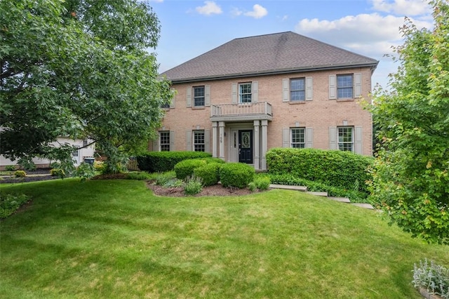 105 Averys Way, Cranberry Twp, PA 16066 - georgian-style home with a front yard, brick siding, and a balcony