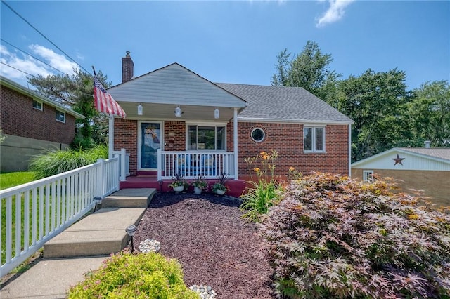 628 Illini, Monroeville, PA 15146 - bungalow featuring covered porch, brick siding, and a chimney