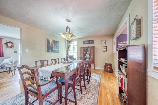 628 Illini, Monroeville, PA 15146 - dining space featuring a textured ceiling and light wood finished floors